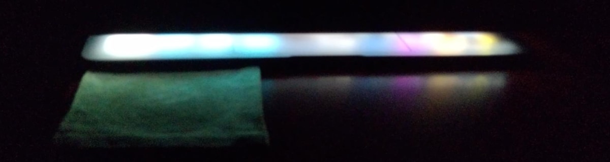 The lights from an almost closed laptop