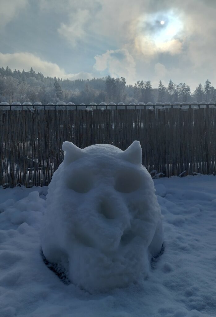 A snowman in the shape of a skull, dramatic sky