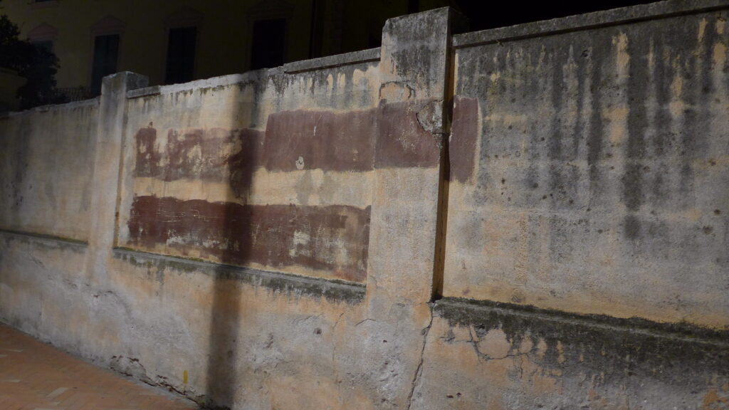 Reverse graffiti in dark brown on a wall in light brown