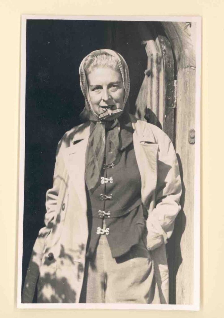 Artist Claude Cahu with an antifascist gesture, bites on a nazi symbol