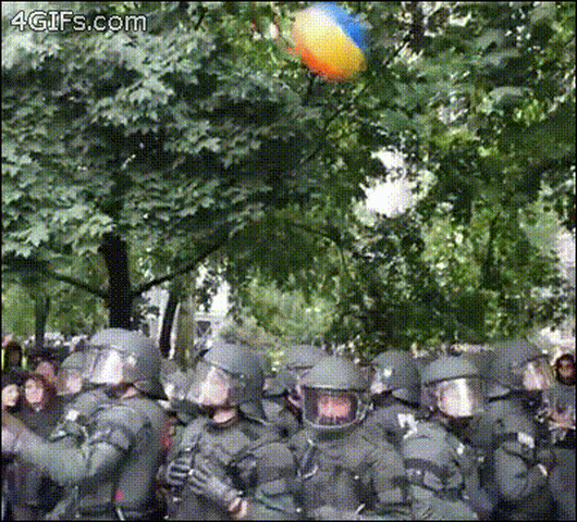A beach ball is bouncing on a row of robocops